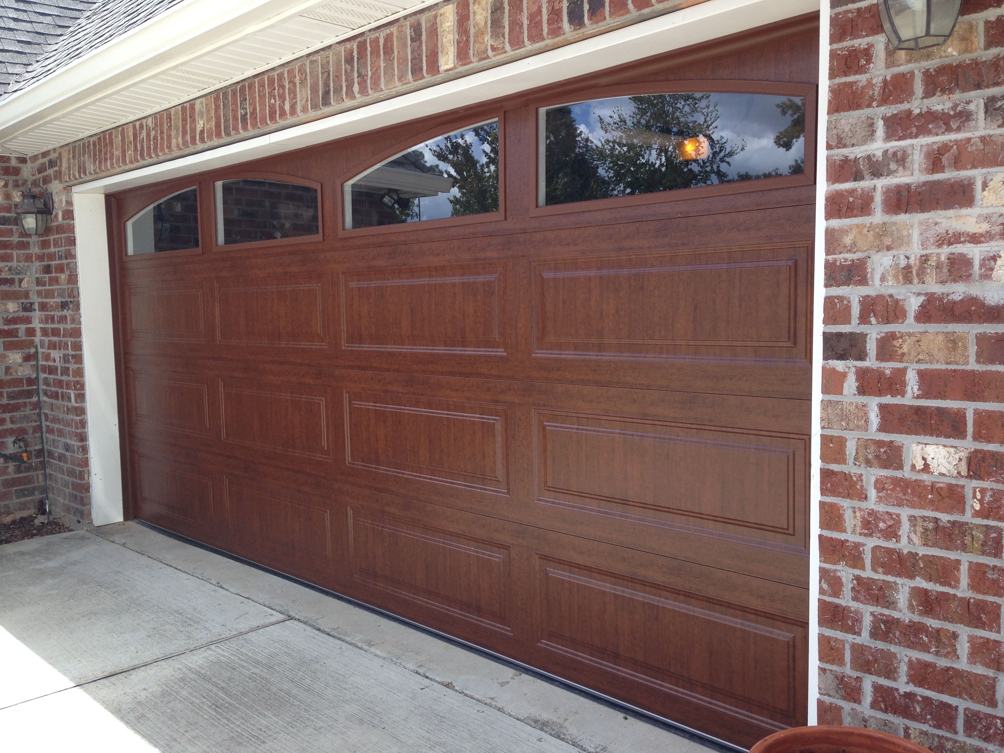 The Beauty of Stained Wood Crescent City Garage Door